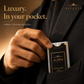 Alpha pocket perfume held, showing its card-sized format